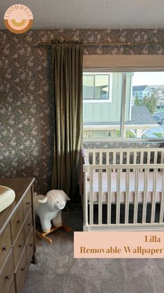 a baby crib and dresser in a room with floral wallpaper on the walls