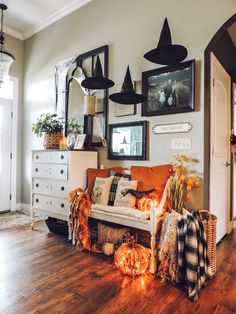 a living room filled with lots of furniture and pictures hanging on the wall above it