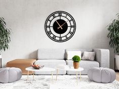 a living room filled with furniture and a large clock on the wall above it's face