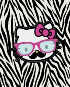 a hello kitty with glasses and a mustache on zebra print fabric, as if it were from the 80's or 90's