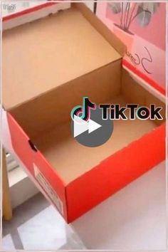 an open box sitting on top of a white table next to a window with the words tiktok written in it