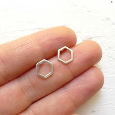 "Dainty sterling silver hexagon honeycombs are soldered to sterling silver studs to create these minimal earrings. . { m e a s u r e m e n t s } . ~ 1/3\" . { o p t i o n s } . Other Post Earring Styles: https://www.etsy.com/shop/CamileeDesigns?section_id=10245147&ref=shopsection_leftnav_3 . { p a c k a g i n g } . Your jewelry will arrive in a cute box - perfect for giving or keeping for yourself. . { s h i p p i n g } . Handmade in my studio and shipped via USPS mail with tracking. Please Nickel-free Hexagon Earrings As A Gift, Nickel-free Hexagon Earrings For Gift, Minimalist Sterling Silver Octagon Jewelry, Minimalist Octagon Sterling Silver Jewelry, Minimalist Silver Octagon Jewelry, Modern Sterling Silver Hexagon Jewelry, Minimalist Hexagon Sterling Silver Jewelry, Honey Combs, Earring Styles