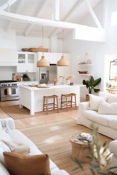 a living room filled with furniture and a kitchen