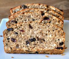 slices of banana bread with raisins and nuts on a white plate, ready to be eaten