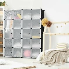 a child's room with toys and storage bins on the wall next to a bed