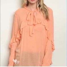 This Darling Boutique Blouse Features A Soft Peach Base, Ruffled Details And Feminine Flowy Body. So Flattering & Pretty! This Blouse Can Be Layers Over A Lace Hem Camisole For An Extra Feminine Touchavailable For Sale In This Closet. Elastic At The End Of The Sleeves. Photos Show Actual Measurements For Size Medium. Measurements For The Size Small : Pit To Pit: 20 Inches, 26" Length Private Label Fabric: Rayon Chic Ruffled Blouse For Spring, Spring Ruffled Collar Blouse For Brunch, Spring Brunch Blouse With Ruffled Collar, Spring Ruffle Blouse For Brunch, Spring Brunch Blouse With Ruffles, Spring Ruffled Collar Top For Brunch, Spring Brunch Tops With Ruffled Collar, Feminine Spring Blouse With Ruffles, Spring Ruffled Blouse For Day Out