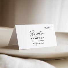 a place card sitting on top of a white plate