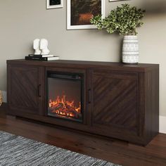 a living room with a fireplace and pictures on the wall