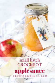 small batch crockpot applesauce in a mason jar with an apple beside it