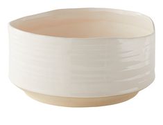 a white bowl sitting on top of a wooden table