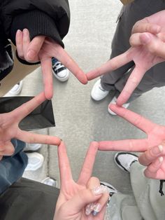 several people making the shape of a star with their hands and fingers in front of them