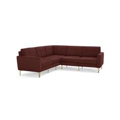 a large sectional couch with wooden legs and a dark red upholstered sofa cushion