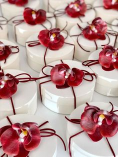 many small white boxes with red flowers on them