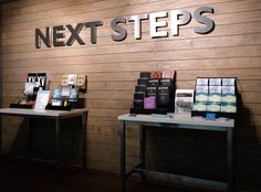 two tables with books on them in front of a sign that reads next steps and the words