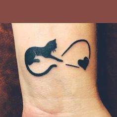 a black cat with a heart on it's wrist is holding onto a string