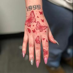 a woman's hand with red butterflies on it and the word happy written in black ink