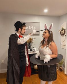 a man and woman dressed up as bunny and rabbit for halloween costume party, standing next to each other