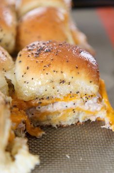 the sliders are covered with cheese and black sesame seeds