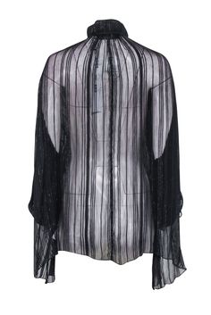 Get ready to rock any occasion in this semi-sheer black blouse with metallic details from IRO. Perfectly pairs with leather leggings and heeled boots for a chic and edgy look. So versatile, you'll want to wear it everywhere! Size 2 (FR 34) 64% Viscose, 35% Cupro, 1% Metallized Fiber Unlined V-neckline detail Long sleeve Semi sheer Bust 62" Waist 65" Shoulder to hem 32" Sleeve length 29" Edgy Sheer Tops For Evening, Edgy Sheer Top For Evening, Sleek Winter Party Tops, Sheer Evening Tops For Winter, Elegant Sheer Tops For Party Season, Sleek Sheer Tops For Party, Glamorous Black Sheer Blouse, Glamorous Sheer Blouse For Night Out, Sheer Evening Blouse For Fall