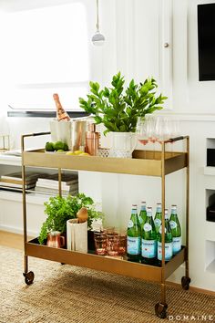 a bar cart filled with bottles and glasses