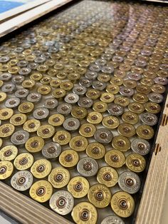 there are many different types of buttons on the table top, including one that is covered in gold and silver