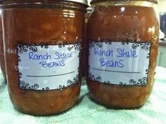 two jars of peanut butter sitting on top of a table