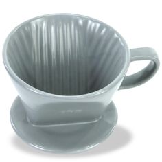 a white coffee cup sitting on top of a saucer