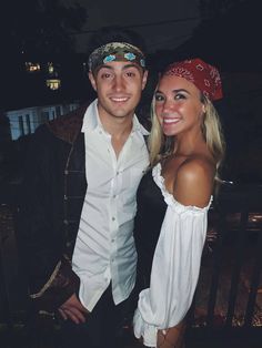 a man standing next to a woman wearing a bandana