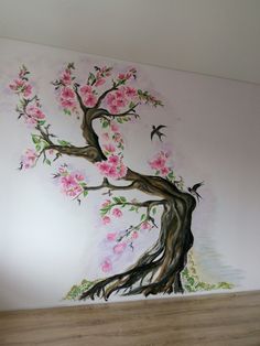 a painted tree with pink flowers on the wall