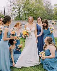 a group of women standing next to each other on top of a lush green field