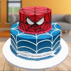 a spiderman birthday cake on a white plate