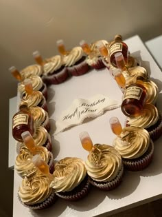 cupcakes are arranged in the shape of a wreath on top of a card