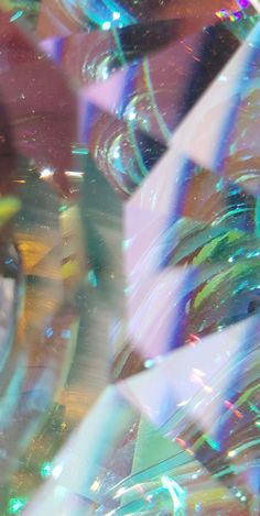 a close up view of the inside of a glass vase with many different colors and shapes