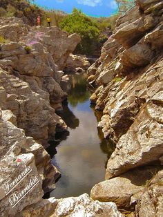 an image of a river surrounded by rocks