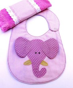 a pink bib with an elephant applique on it