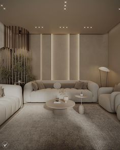 a living room filled with white couches and tables