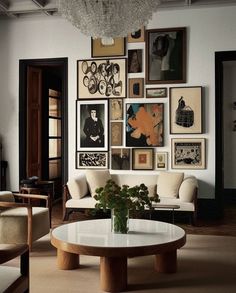 a living room filled with furniture and pictures on the wall