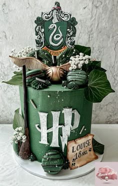 a green cake with harry potter decorations on it