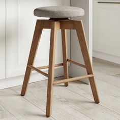 a wooden stool with a grey seat in a white kitchen