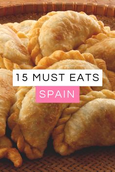 a basket full of fried food with the words 15 must eats spain