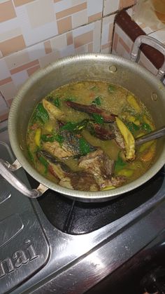 a pan filled with food sitting on top of a stove