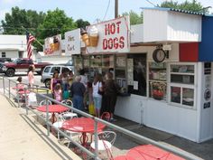 people are lined up at the ice cream stand