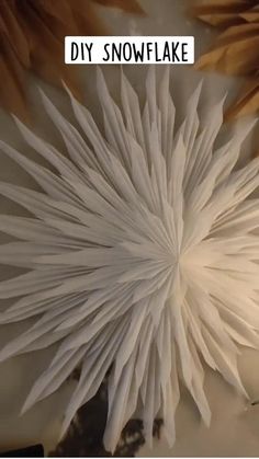 a close up of a paper flower with the words diy snowflake on it