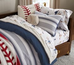 a baseball themed comforter set on a bed