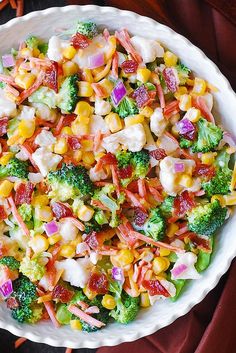 a white bowl filled with corn and broccoli salad