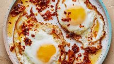 two fried eggs are in a bowl on the table