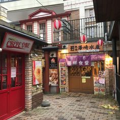 the outside of a chinese restaurant with red doors