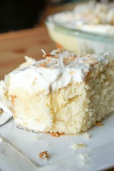 a piece of coconut cream pie poke cake on a plate