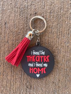 a keychain with a tassel hanging from it's side that says, i found the theatre and i found my home