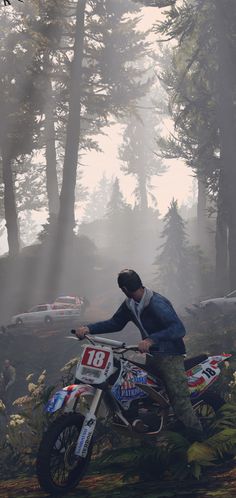 a man riding on the back of a dirt bike through a forest filled with trees